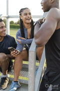 Group of athletes sitting on steps at stadium