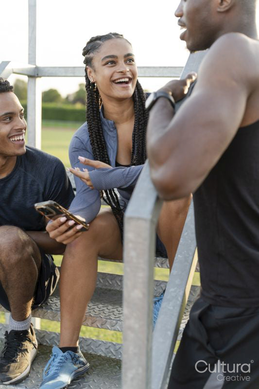 Group of athletes sitting on steps at stadium