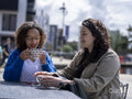 Smiling couple enjoying coffee at sidewalk cafe table