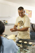 Members of family preparing food in kitchen