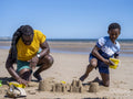 Father and son building sand castles on beach