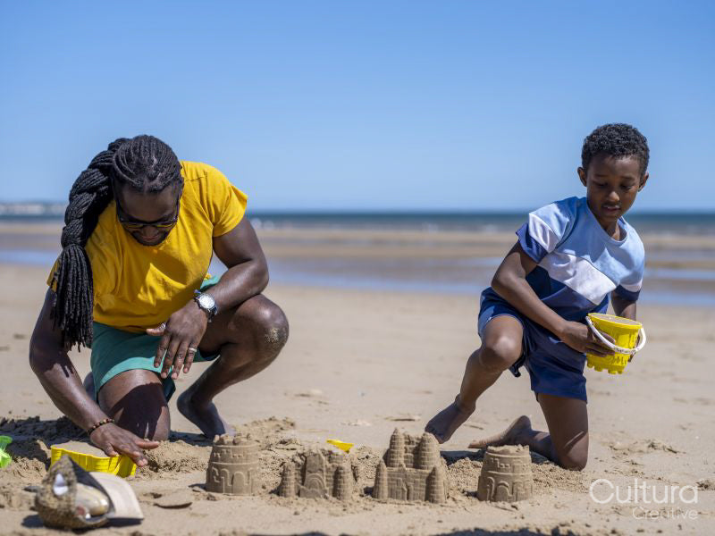 Father and son building sand castles on beach