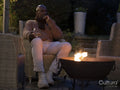 Man sitting by fire pit on patio