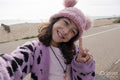 Portrait of smiling girl making peace gesture while taking selfie