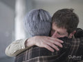 Man and woman hugging in therapy session
