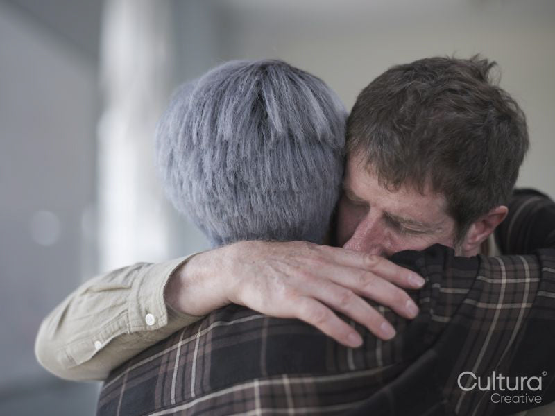 Man and woman hugging in therapy session