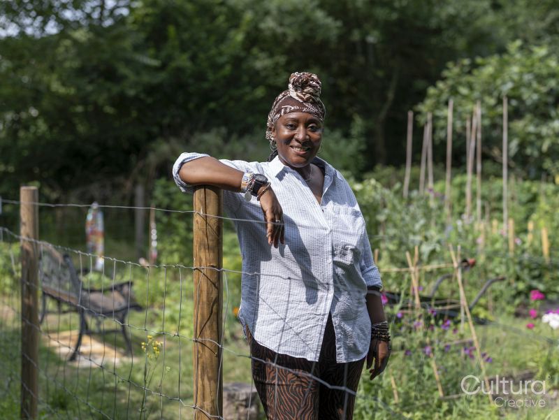 Portrait of smiling mature woman standing in garden