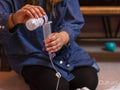 Woman pouring water into feeding tube