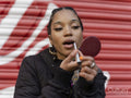 Young woman applying make-up