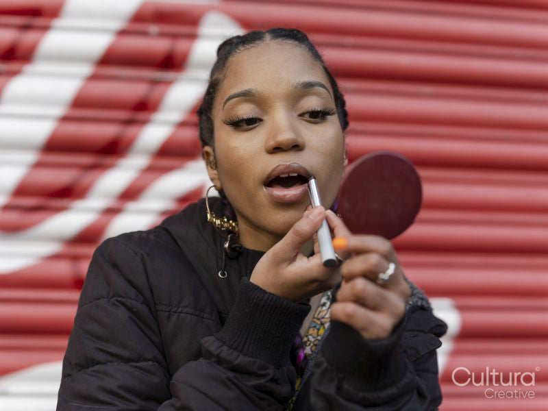 Young woman applying make-up