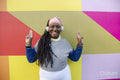 Portrait of beautiful woman with dreadlocks on colorful background