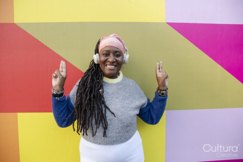 Portrait of beautiful woman with dreadlocks on colorful background