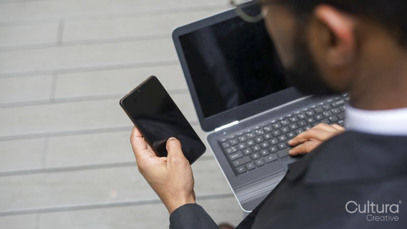 Business man using laptop and mobile phone