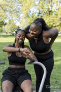 Young female friends exercising in outdoor gym