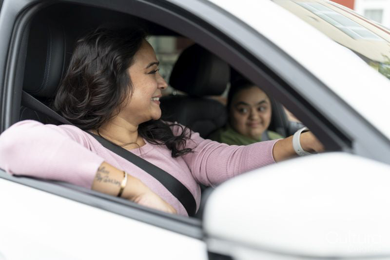 Mother driving car with down syndrome daughter