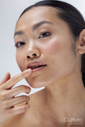 Studio portrait of woman touching lips