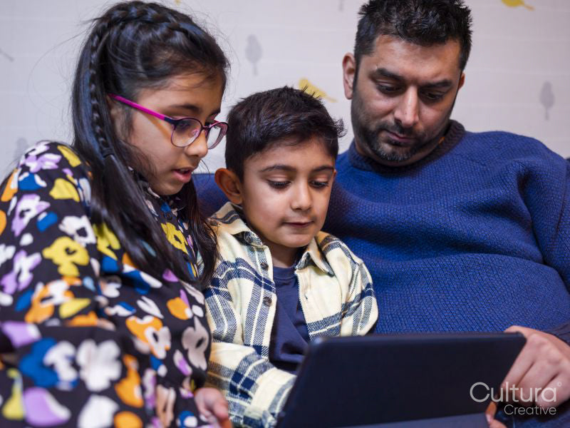 Father and children using digital tablet