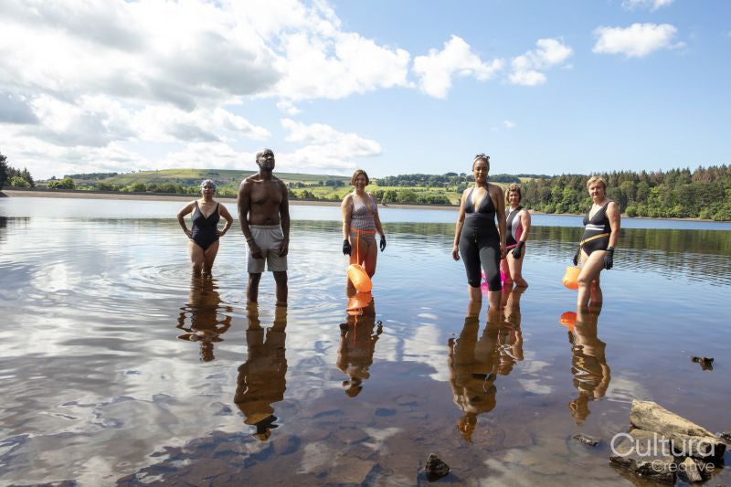 Portrait of group of friends standing in lake, Yorkshire, UK