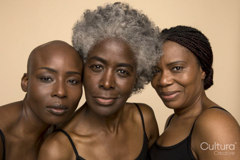Studio portrait of three smiling women