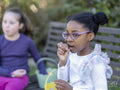 Girl friends eating Easter chocolate eggs