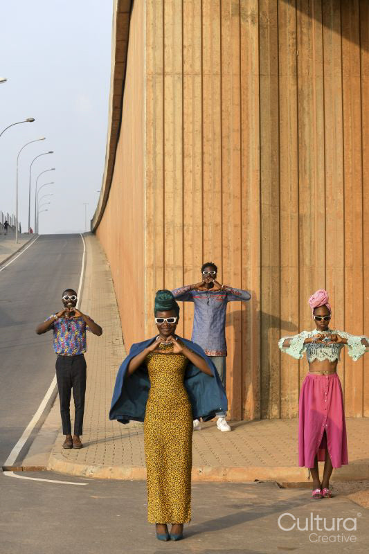 Fashion shot of four people standing in urban street