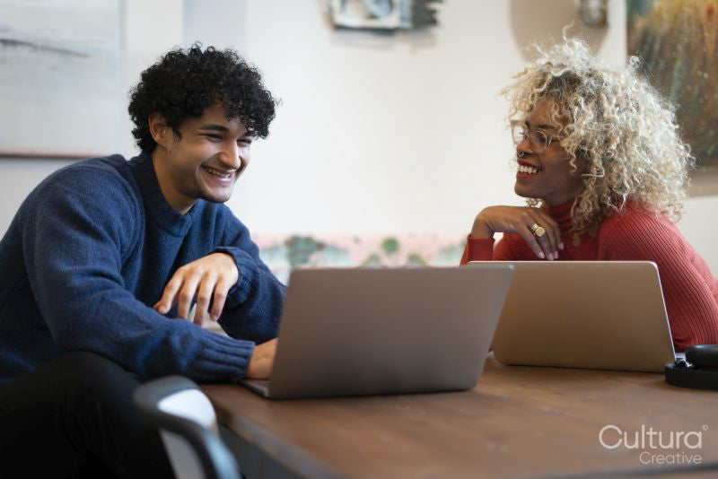 Creative professionals working on laptops in office