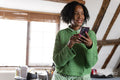 Portrait of businesswoman using phone in office