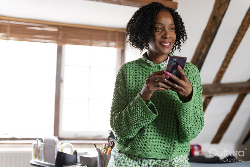 Portrait of businesswoman using phone in office