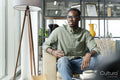 Young man sitting in office lounge