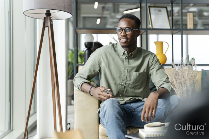 Young man sitting in office lounge