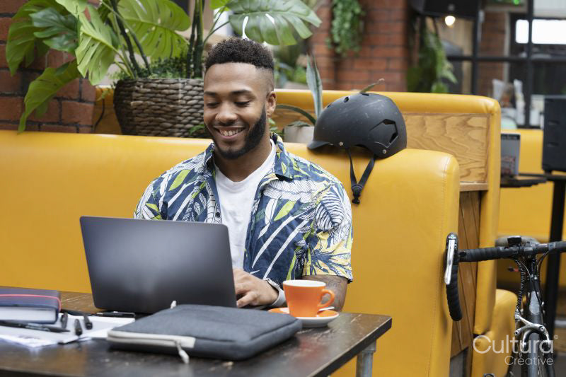 Man sitting in office lounge using laptop
