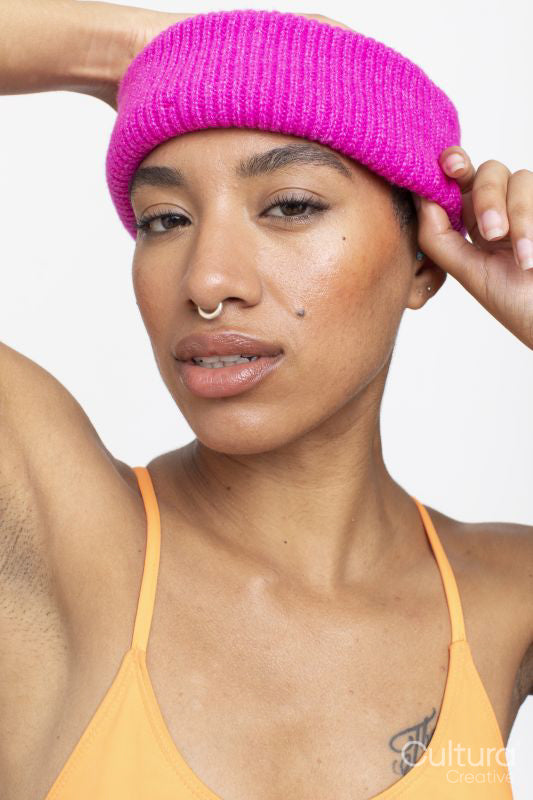 Studio portrait of woman in pink woolen cap