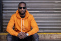 South Yorkshire, Portrait of man in yellow shirt land sunglasses