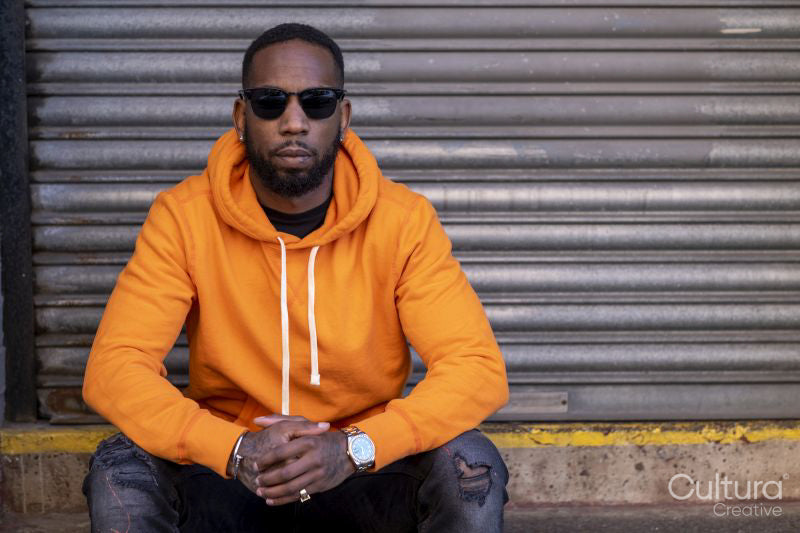 South Yorkshire, Portrait of man in yellow shirt land sunglasses