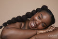 Studio portrait of smiling young woman with braided hair