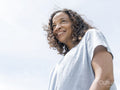 Portrait of smiling woman against sky