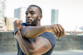 Mid adult man stretching in urban setting