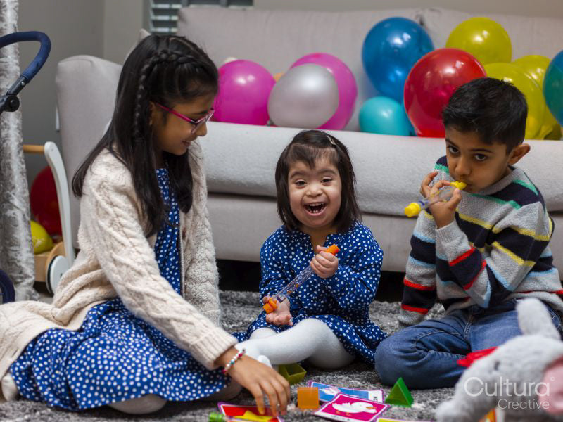 Smiling siblings playing at home