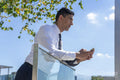 Businessman using phone outdoors