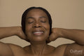 Studio shot of smiling mature woman with braided hair and eyes closed