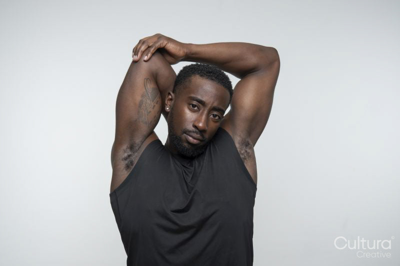 Portrait of muscular man stretching arms