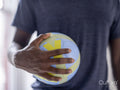 Midsection of person holding soccer ball