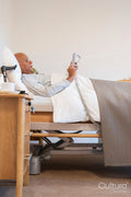 Senior man lying in adjustable bed in room at nursing home