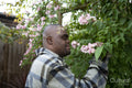 Man with Down syndrome smelling tree blossom
