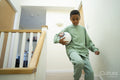 Boy walking down stairs with soccer ball