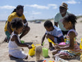Family with children playing on beach