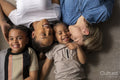 Mothers and sons cuddling on floor