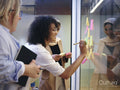 Women using adhesive notes in office