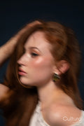 Studio portrait of a woman in a yellow dress with windswept hair