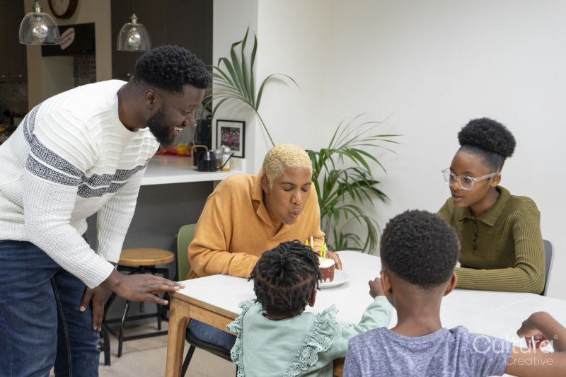 Family with children celebrating birthday at home